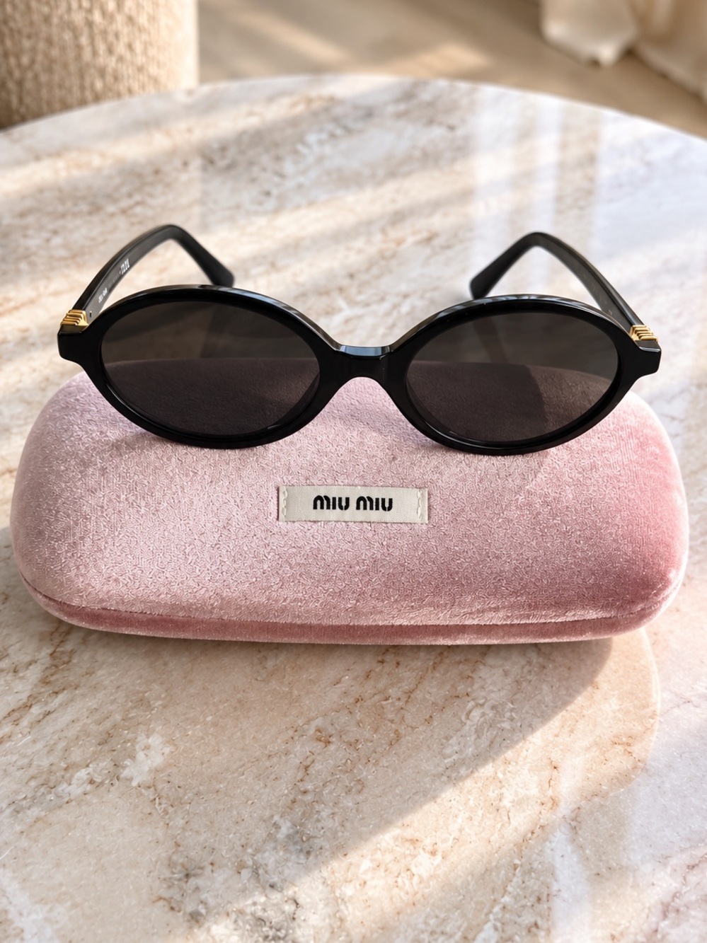Miu Miu Black Oval Sunglasses with Dark Lenses